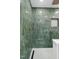 Elegant shower with green tile, a built-in niche, and modern fixtures at 301 Lord Berkley Rd, Raleigh, NC 27610