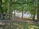 Lush backyard featuring mature trees, a well-maintained lawn, and a charming deck perfect for outdoor enjoyment at 304 Indigo Pl, Garner, NC 27529