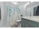 Cozy bathroom with modern updates, a stylish vanity, and a decorative shower curtain at 304 Indigo Pl, Garner, NC 27529