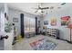 Bright bedroom with colorful decor, a ceiling fan, and ample space for play at 304 Indigo Pl, Garner, NC 27529