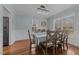Elegant dining room with wood floors, wainscoting, and a stylish chandelier at 304 Indigo Pl, Garner, NC 27529