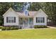 Charming home featuring a well-maintained lawn, classic white siding and a welcoming front porch at 304 Indigo Pl, Garner, NC 27529