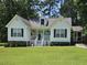 Charming one-story home with a well-manicured front yard and inviting, covered front porch at 304 Indigo Pl, Garner, NC 27529