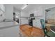 Well-lit kitchen featuring white cabinets, modern appliances, and a view into the dining area at 304 Indigo Pl, Garner, NC 27529