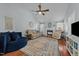 Bright living room with a fireplace, high ceilings and hardwood flooring at 304 Indigo Pl, Garner, NC 27529
