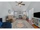 Bright living room features a ceiling fan, fireplace, and beautiful hardwood floors at 304 Indigo Pl, Garner, NC 27529