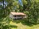 Aerial view of home with a sprawling, lush green lawn surrounded by mature trees at 3044 Rock Springs Church Rd, Creedmoor, NC 27522