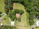 Aerial view of home surrounded by mature trees, with a mix of open lawn space and forest, and a barn on the property at 3044 Rock Springs Church Rd, Creedmoor, NC 27522