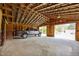 Spacious barn featuring an open interior, concrete floors, and exposed wooden framework with a pick-up truck inside at 3044 Rock Springs Church Rd, Creedmoor, NC 27522