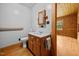 Bathroom with a wooden vanity, framed mirror and a view into the next room at 3044 Rock Springs Church Rd, Creedmoor, NC 27522