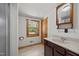 Bright bathroom with dark wood vanity, framed mirror, and window with a view at 3044 Rock Springs Church Rd, Creedmoor, NC 27522