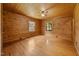 Bedroom with wood paneled walls and ceiling, wood flooring and two windows at 3044 Rock Springs Church Rd, Creedmoor, NC 27522