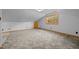 Large bonus room with plush carpet and natural trim around the window and baseboards at 3044 Rock Springs Church Rd, Creedmoor, NC 27522