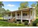 Charming home featuring a welcoming front porch and beautiful landscaping at 3044 Rock Springs Church Rd, Creedmoor, NC 27522