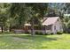 Exterior of a home featuring a screened-in porch and expansive front yard at 3044 Rock Springs Church Rd, Creedmoor, NC 27522