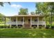 Inviting front exterior with a charming porch and well-manicured lawn at 3044 Rock Springs Church Rd, Creedmoor, NC 27522