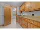 Kitchenette area with pine cabinets, laminate countertops, stainless sink, and view into bonus room at 3044 Rock Springs Church Rd, Creedmoor, NC 27522