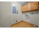 Utility room featuring wood floors, cabinet and laundry hookups at 3044 Rock Springs Church Rd, Creedmoor, NC 27522