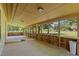 Large screened porch with wood flooring and views of the outdoor landscape at 3044 Rock Springs Church Rd, Creedmoor, NC 27522