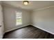 Cozy bedroom featuring hardwood floors and a bright window, providing ample natural light at 307 N Church St, Kenly, NC 27542