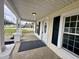 Covered front porch showcases classic columns, black railings, and access to the front door at 307 N Church St, Kenly, NC 27542
