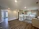 Spacious kitchen featuring new cabinets, countertops, and appliances with views into other rooms at 307 N Church St, Kenly, NC 27542