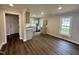 Open-concept kitchen featuring gray cabinets, modern appliances, and plenty of natural light at 307 N Church St, Kenly, NC 27542