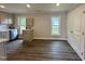 Eat-in kitchen with stainless steel appliances, wood floors, and abundant natural light at 307 N Church St, Kenly, NC 27542