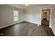 Open-concept living room featuring new floors, neutral color palette, and views into the kitchen at 307 N Church St, Kenly, NC 27542
