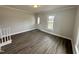 Bright living room with new floors, neutral paint, and natural light from the front window at 307 N Church St, Kenly, NC 27542