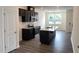 A modern kitchen with stainless steel appliances, an island and dark cabinetry at 3105 White Blossom Ct, Raleigh, NC 27610