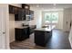 An open-concept kitchen with stainless steel appliances, island, and hardwood flooring at 3105 White Blossom Ct, Raleigh, NC 27610