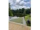 Back deck overlooking a pond with lush greenery and an AC unit at 3204 Overlook Ct, Burlington, NC 27215