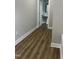 Hallway featuring a view to a bathroom with wood-look flooring at 3204 Overlook Ct, Burlington, NC 27215