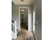 Hallway leading to a bathroom with wood-look flooring at 3204 Overlook Ct, Burlington, NC 27215