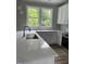 Close-up of kitchen's quartz countertop, undermount sink, stainless steel oven and leafy outdoor views at 3204 Overlook Ct, Burlington, NC 27215