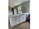Kitchen island with stylish cabinets, stainless steel dishwasher, and open view to the home's entryway at 3204 Overlook Ct, Burlington, NC 27215