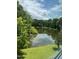Beautiful pond surrounded by trees at 3204 Overlook Ct, Burlington, NC 27215