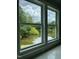 Scenic view of a pond and trees through a large window at 3204 Overlook Ct, Burlington, NC 27215