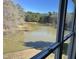 Scenic view of the lake and trees from a window with black panes at 3204 Overlook Ct, Burlington, NC 27215