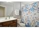 Bathroom featuring a single sink vanity, mirror, toilet, and a shower/tub with patterned curtains at 33 Village Walk Dr, Chapel Hill, NC 27517