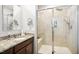 Bright bathroom showcasing granite counters, and a tiled walk-in shower with a built-in seat at 33 Village Walk Dr, Chapel Hill, NC 27517