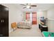 Bedroom featuring a ceiling fan, carpeted floors, neutral walls, and a window with orange curtains at 33 Village Walk Dr, Chapel Hill, NC 27517