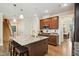 Spacious kitchen featuring an island with seating and stainless steel appliances at 33 Village Walk Dr, Chapel Hill, NC 27517