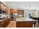 Open kitchen featuring an island with bar stools, granite counters and stainless appliances at 33 Village Walk Dr, Chapel Hill, NC 27517