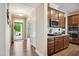 Open floor plan from entry hall to kitchen with stainless appliances and wood floors at 33 Village Walk Dr, Chapel Hill, NC 27517