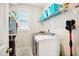 Bright laundry room featuring modern washer and dryer units, shelving, and ample storage space at 33 Village Walk Dr, Chapel Hill, NC 27517