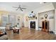 Spacious living room with hardwood floors, fireplace, ceiling fan, recessed lighting, and comfortable seating at 33 Village Walk Dr, Chapel Hill, NC 27517