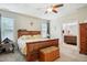 Bedroom featuring a ceiling fan, natural light, carpet flooring and a glimpse into the connected bathroom at 33 Village Walk Dr, Chapel Hill, NC 27517