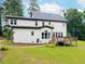 Exterior view of home, with a wooden deck, lush green lawn, and mature landscaping at 3901 Phlox Rd, Raleigh, NC 27616